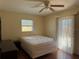 Bedroom featuring laminate floors, ceiling fan, and sliding glass door at 1036 Hope St, Venice, FL 34285
