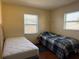 Cozy bedroom with two twin beds and wood flooring at 1036 Hope St, Venice, FL 34285