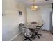 Cozy dining area with glass table, chandelier, and door leading to the outside at 1036 Hope St, Venice, FL 34285