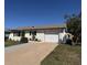 Charming single-story home featuring a well-maintained lawn and attached garage with ample parking space at 1036 Hope St, Venice, FL 34285