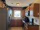 Functional kitchen featuring wood cabinets, stainless steel appliances, and tile backsplash at 1036 Hope St, Venice, FL 34285