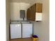 Utility room with a washing machine, dryer, and overhead cabinets at 1036 Hope St, Venice, FL 34285