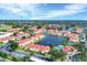Scenic aerial view of the community's condos surrounding a tranquil lake and featuring a refreshing pool at 1110 Villagio Cir # 103, Sarasota, FL 34237