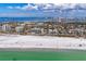 Aerial beach shot with turquoise water and white sand, buildings, and happy beach goers in Sarasota, Florida at 1110 Villagio Cir # 103, Sarasota, FL 34237