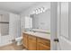 Well-lit bathroom with tile flooring, wood vanity, and shower/tub combination at 1110 Villagio Cir # 103, Sarasota, FL 34237