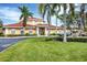 Exterior shot of clubhouse with palm trees and fountain at 1110 Villagio Cir # 103, Sarasota, FL 34237