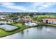 Scenic aerial shot highlighting a community pool, tennis courts, baseball fields, and a lake, offering diverse recreational options at 1110 Villagio Cir # 103, Sarasota, FL 34237