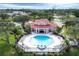 An overhead view shows a pool house next to a crystal-clear blue pool with lounge chairs surrounding the amenity at 1110 Villagio Cir # 103, Sarasota, FL 34237