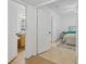 Open hallway leads to bathroom and bedroom with tile flooring throughout the house at 1110 Villagio Cir # 103, Sarasota, FL 34237