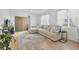 Bright living room featuring a neutral sectional sofa, tile floors, and sliding doors to the outdoor patio at 1110 Villagio Cir # 103, Sarasota, FL 34237