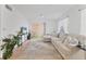 Bright, comfortable living room with neutral walls, tile flooring, and sliding glass doors to outdoor area at 1110 Villagio Cir # 103, Sarasota, FL 34237