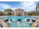 Stunning pool area with fountains and a covered lounge area, providing a luxurious outdoor experience at 1110 Villagio Cir # 103, Sarasota, FL 34237