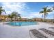 Resort-style pool area with comfortable lounge chairs and well-maintained landscaping, perfect for relaxation and recreation at 1110 Villagio Cir # 103, Sarasota, FL 34237
