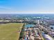 An aerial view showcases homes backing to ponds and green fields under a clear blue sky at 11213 2Nd E Ave, Bradenton, FL 34212
