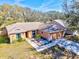 Aerial view of the home, showcasing the driveway, garage, and colorful, landscaped front yard at 11213 2Nd E Ave, Bradenton, FL 34212