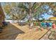 Large wooden deck in a backyard with mature trees, offering a great space for outdoor living and dining at 11213 2Nd E Ave, Bradenton, FL 34212