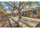 Backyard showcasing a spacious deck with multiple seating areas for outdoor relaxation and entertainment with mature trees at 11213 2Nd E Ave, Bradenton, FL 34212