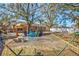 Backyard retreat with a hammock and colorful Adirondack chairs for relaxing at 11213 2Nd E Ave, Bradenton, FL 34212