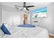 Comfortable bedroom with a ceiling fan, television, and double closet for ample storage at 11213 2Nd E Ave, Bradenton, FL 34212