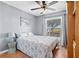 Comfortable bedroom with a floral comforter set, a ceiling fan and natural light at 11213 2Nd E Ave, Bradenton, FL 34212