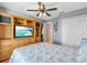Comfortable bedroom featuring a ceiling fan and built-in media center with ample storage at 11213 2Nd E Ave, Bradenton, FL 34212