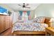Inviting bedroom featuring a large bed, a ceiling fan, and plenty of natural light at 11213 2Nd E Ave, Bradenton, FL 34212