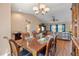 Cozy dining area with wood table set for six, adjacent to living room at 11213 2Nd E Ave, Bradenton, FL 34212