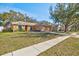 Well-maintained single-story home with a green lawn, and a paved driveway at 11213 2Nd E Ave, Bradenton, FL 34212