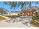 A wide shot of a single story house with a two car garage and a paved driveway at 11213 2Nd E Ave, Bradenton, FL 34212