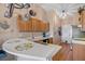 Bright kitchen features wooden cabinetry, stainless steel appliances and a pot rack for storage at 11213 2Nd E Ave, Bradenton, FL 34212