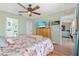 Spacious main bedroom features a ceiling fan, wood flooring, and a view to the living area at 11213 2Nd E Ave, Bradenton, FL 34212