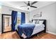 Serene main bedroom with large window, dark furnishings and light hardwood floors at 11213 2Nd E Ave, Bradenton, FL 34212