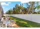 Charming backyard features a small stone patio and a beautiful white privacy fence at 11553 11Th E Ave, Bradenton, FL 34212