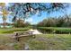 A picturesque pond view with picnic table invites relaxation amidst nature's beauty at 11553 11Th E Ave, Bradenton, FL 34212