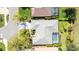 Aerial view reveals lush landscaping, pool, and neighboring homes in a well-kept community at 129 Wayforest Dr, Venice, FL 34292