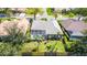 Aerial view of the property showcases a screened-in pool, fenced backyard, and well-maintained landscaping at 129 Wayforest Dr, Venice, FL 34292
