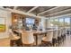 Upscale bar area featuring a full bar, seating, and outdoor view at 129 Wayforest Dr, Venice, FL 34292