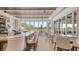 Bright bar area with outdoor views, counter seating, and tables at 129 Wayforest Dr, Venice, FL 34292
