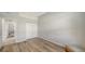 Empty bedroom featuring wood floors, large closet and a cushioned ottoman at 129 Wayforest Dr, Venice, FL 34292