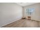 Empty bedroom featuring a small side table, and bright wood floors and a window at 129 Wayforest Dr, Venice, FL 34292