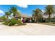 Inviting clubhouse entrance features lush landscaping and a covered portico, exuding tropical charm and convenience at 129 Wayforest Dr, Venice, FL 34292