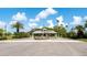 The Venice Golf and Country Club entrance, with security features and lush landscaping at 129 Wayforest Dr, Venice, FL 34292