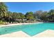 Inviting community pool surrounded by lush landscaping and comfortable lounge chairs offers a tranquil escape for relaxation at 129 Wayforest Dr, Venice, FL 34292