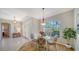 Cozy dining area featuring a glass table, decorative lighting, and access to other living spaces at 129 Wayforest Dr, Venice, FL 34292