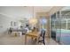 Bright dining area with a view to the screened in lanai and pool at 129 Wayforest Dr, Venice, FL 34292