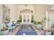 Welcoming entrance with elegant double doors, lush greenery, and stylish decor at 129 Wayforest Dr, Venice, FL 34292