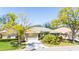 Beautiful home with mature trees and landscaping, complemented by a well-maintained two-car garage at 129 Wayforest Dr, Venice, FL 34292