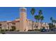 Venice Theatre exterior showcases peach stucco, red tile roofs, and a prominent tower under a blue sky at 129 Wayforest Dr, Venice, FL 34292