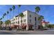 Historic building features red awnings, palm trees, and street-level retail space on a sunny day at 129 Wayforest Dr, Venice, FL 34292