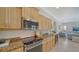 Charming kitchen with wooden cabinetry, granite countertops, and stainless steel appliances at 129 Wayforest Dr, Venice, FL 34292